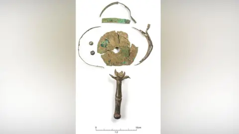 Discover Bucks Museum A close up of a Roman rattle with its various pieces. It includes the peas that went inside the item.