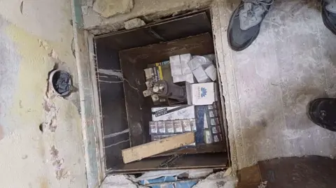 Rochdale Council Illegal goods including cigarettes can be seen hidden under the floor.