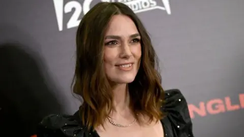 Getty Images Keira Knightley smiling on a red carpet