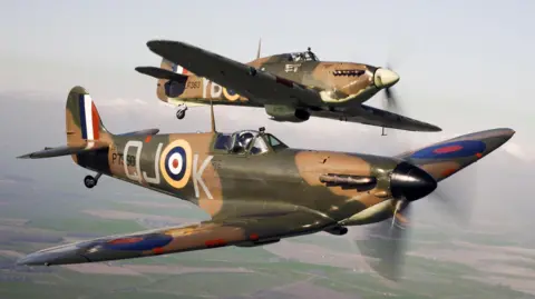 A Spitfire (front) flying alongside a Hurricane from the Battle of Britain Memorial Flight, over RAF Coningsby.