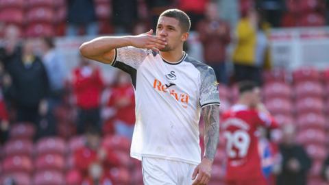 Nathan Wood waves to fans after Swansea's game at former club Middlesbrough
