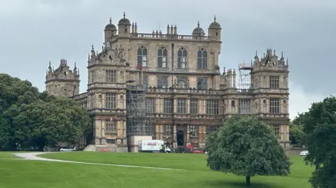 View of Wollaton Hall, an ornate stately home, from across extensive parkland