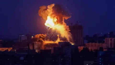Fire and smoke rise following an explosion during a Russian missile and drone strike