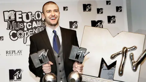 MTV to axe its music TV channels in the UK 6 Getty Images Justin Timberlake smiling and holding two MTV Europe Music Awards alongside a giant MTV logo at the MTV Europe Music Awards 2006 in Copenhagen