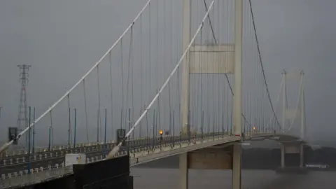 The large M48 Severn Bridge crossing the river on a grey rainy day.