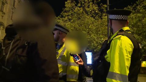 Greater Manchester Police officers carry out stop and search 