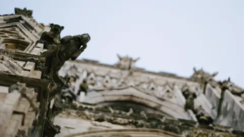 YORK MINSTER Shot of the exterior of the Minster with a view of a grotesque. The camera is looking upwards.