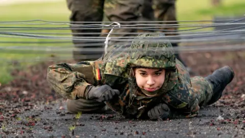 A German soldier crawls during military training, 2021