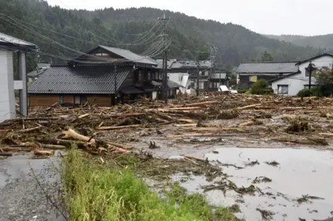 Reuters Debris following torrential rain in the city of Wajima