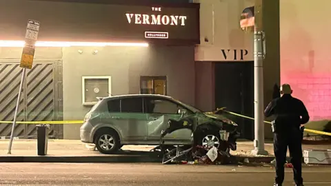 A vehicle that plunged into a crowd outside a nightclub, injuring dozens, is seen on Santa Monica Boulevard in the East Hollywood neighborhood of Los Angeles, California, U.S.