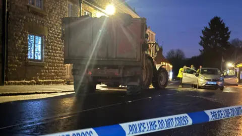 BBC/Luke Manterfield A tractor and trailer behind a police cordon