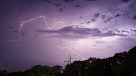 Ryan H Weather Watcher - Ryan H captured this lightning storm with purple skies in Southampton.
