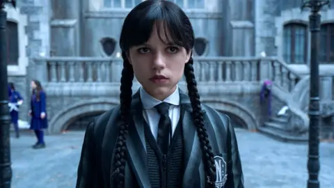 Netflix Jenna Ortega as Wednesday Addams, seen in a school yard in the second season of Netflix's Wednesday