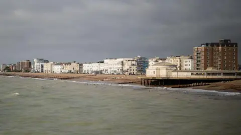A shot of Worthing seafront. There are grey skies above.