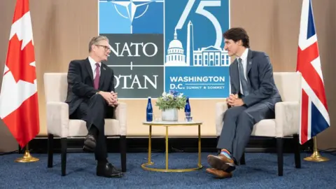 Getty Images British Prime Minister Keir Starmer sits next to Canadian Prime Minister Justin Trudeau at the NATO Washington DC Summit in July 2024.