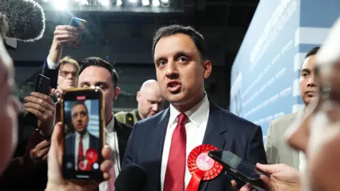 Anas Sarwar speaks to journalists at a vote count