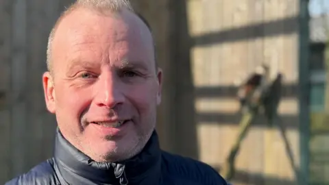 A head and shoulders image of Matthew Jeffery. He is wearing a navy Gillet and looking directly into the camera.