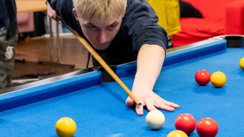 Ourside A child playing pool with the Ourside charity in Worcester 