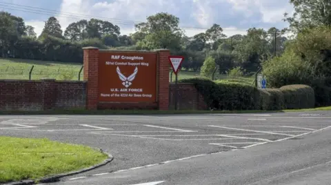 Entrance to airbase with sign for RAF Croughton