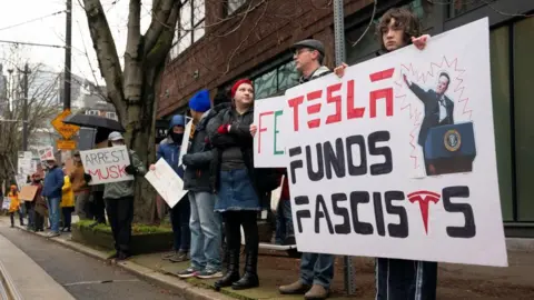 A protest outside a Tesla showroom in Seattle, Washington drew people eager to share their frustration with Elon Musk