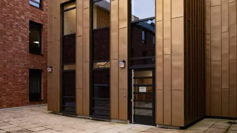 Shropshire Council The front of a red brick building with a brown and black entranceway