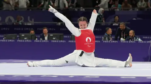 Reuters Amy Truesdale of Britain celebrates winning gold after her bout against Guljonoy Naimova of Uzbekistan