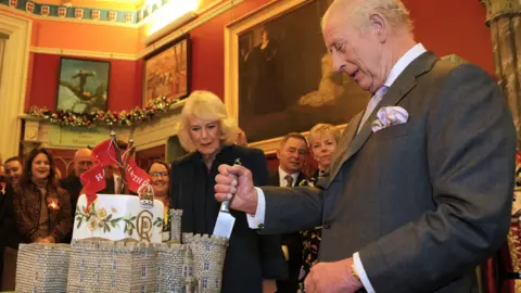 King Charles cuts a cake