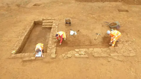 MOLA Archaeologists working on a Roman stone building