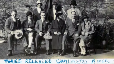 Working Class Movement Library A black and white photograph of three of the miners held responsible for the derailment, following their release from prison - with their wives and mothers