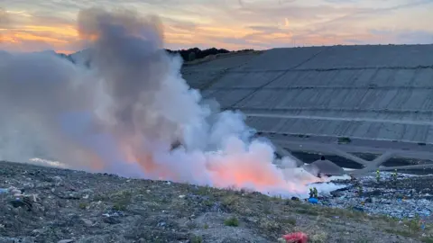 Fire at a quarry in Leicestershire. Smoke is blowing into the air. 
