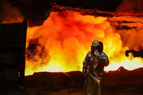 Getty Images A worker beside a blast furnace at the Thyssenkrupp Steel Europe AG steel plant in Duisburg, Germany