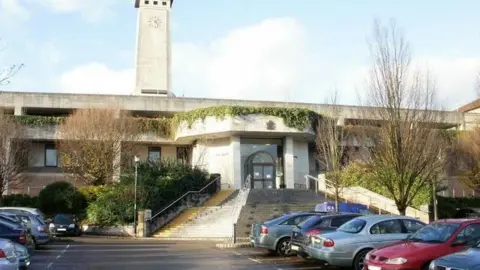 Jaggery/Geograph Newport Crown Court with car park visible and steps up to court behind and concrete facade of court building with clock tower