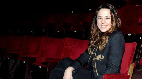 Getty Images Melanie C sits in the red velvet seats for a photo in 2010