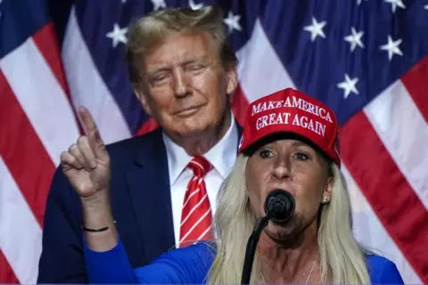 AFP via Getty Images US Representative Marjorie Taylor Greene (R) speaks alongside former US President and 2024 presidential hopeful Donald Trump at a campaign event in Rome, Georgia, on March 9, 2024