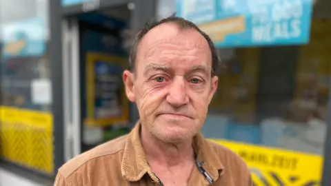 BBC Steven McKenzie is wearing a brown shirt