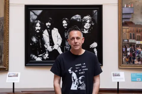 Castle Fine Art Artist Jon Jones stands in front of his artwork at the Birmingham Museum and Art Gallery
