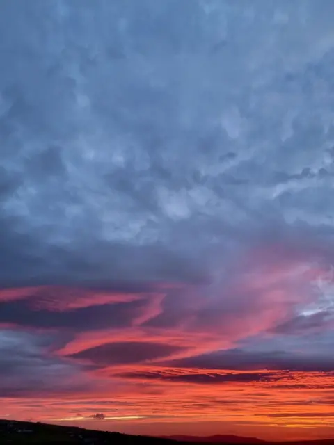 Sebastian Griffiths A sunset with grey clouds above