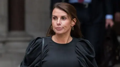 Getty Images Coleen Rooney pictured in May 2022 leaving the Royal Courts of Justice eiddidqxiqhhinv