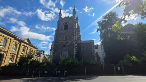 Paul Moseley/BBC We can see the church on a sunny day, with three of the pinnacles on top of the tower visible.