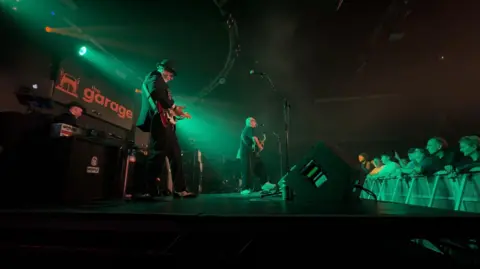 Huey Morgan and his band playing on stage in The Garage nightclub 