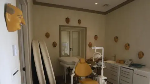 US Congress. A room that looks like a dentist's chair in the middle and masks hanging on the walls.