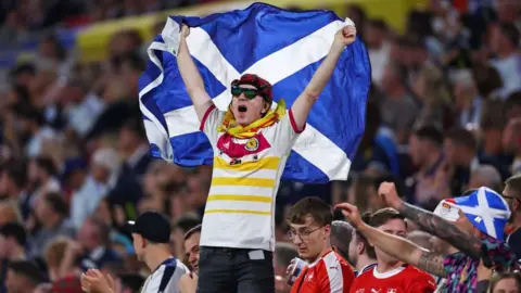 Getty Images A Scotland fan holding a Saltire