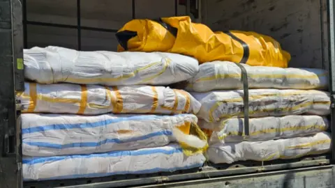 National Crime Agency Inflatable boats, which are flat packed, are stacked up in the back of a lorry that's been stopped by customs officials in Bulgaria