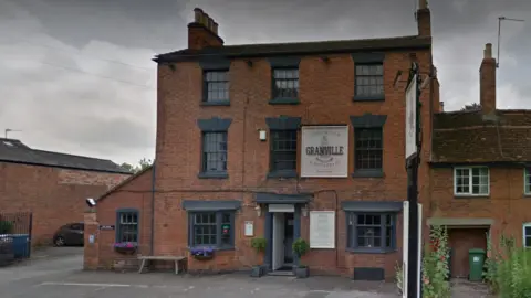 Google Maps The outside of the Granville Arms pub with black windows. It is three storeys high and features a car park out the front of the pub.