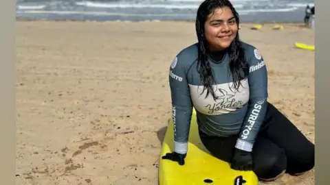 BBC Daniela,17, from El Salvador with a surfing board