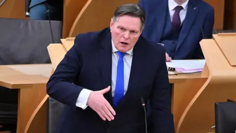 Getty Images Stephen Kerr in the Scottish Parliament.