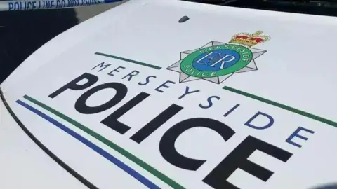 A close up of the bonnet of a Meryside Police car.