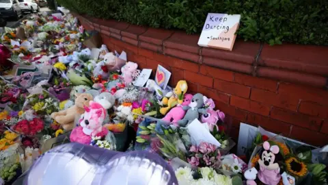 EPA Floral tributes left to the victims of the Southport knife attack