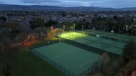 Reuters A drone shot of Herzog Park in south Dublin taken at dusk. There are multiple tennis courts, as well as a large sports court in the foreground of the picture.