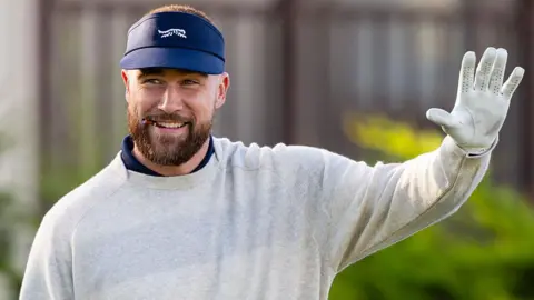 Travis Kelce waves before the start of the second round of the AT&T Pebble Beach Pro-Am in 2026